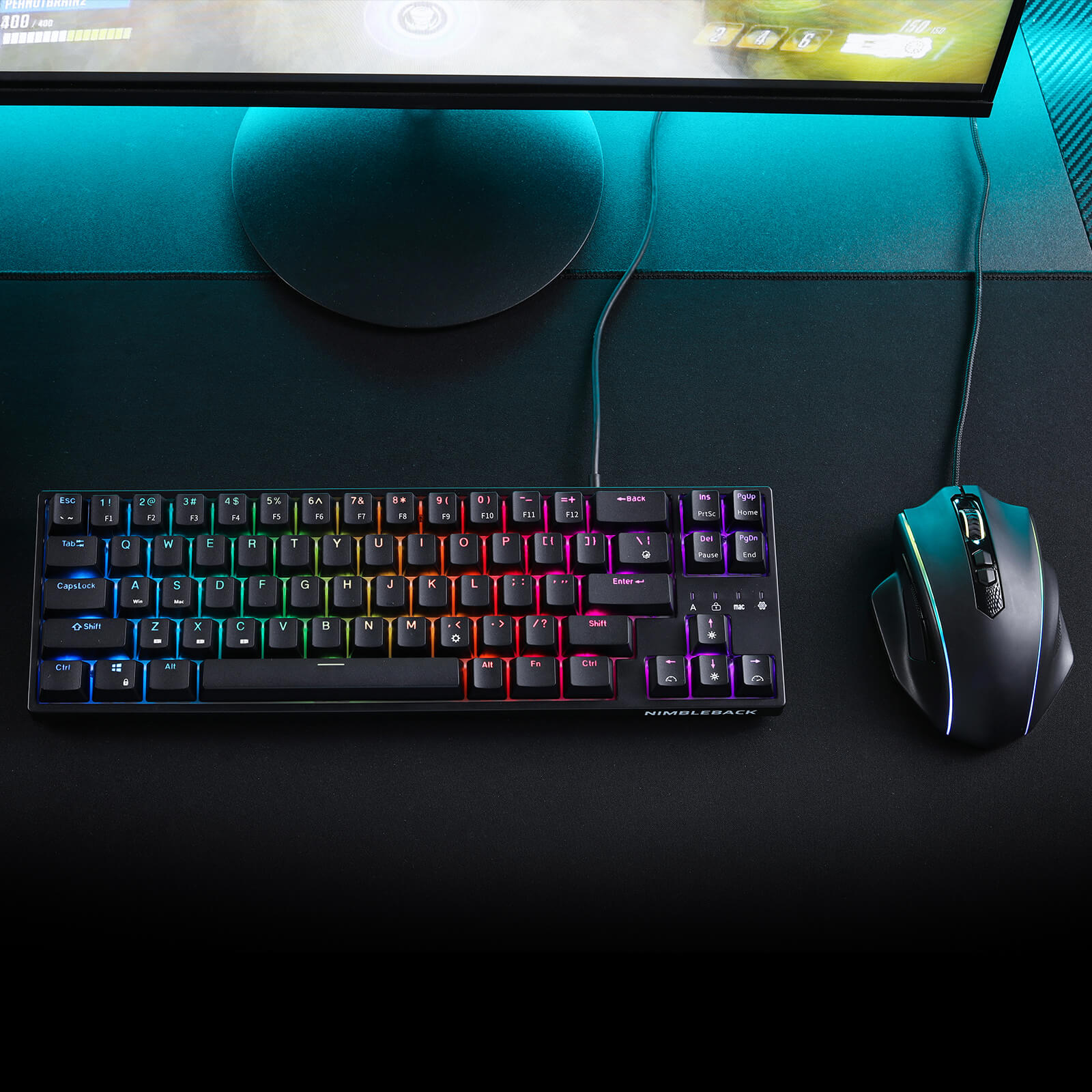 Gaming keyboard and mouse on a desk with a monitor in the background