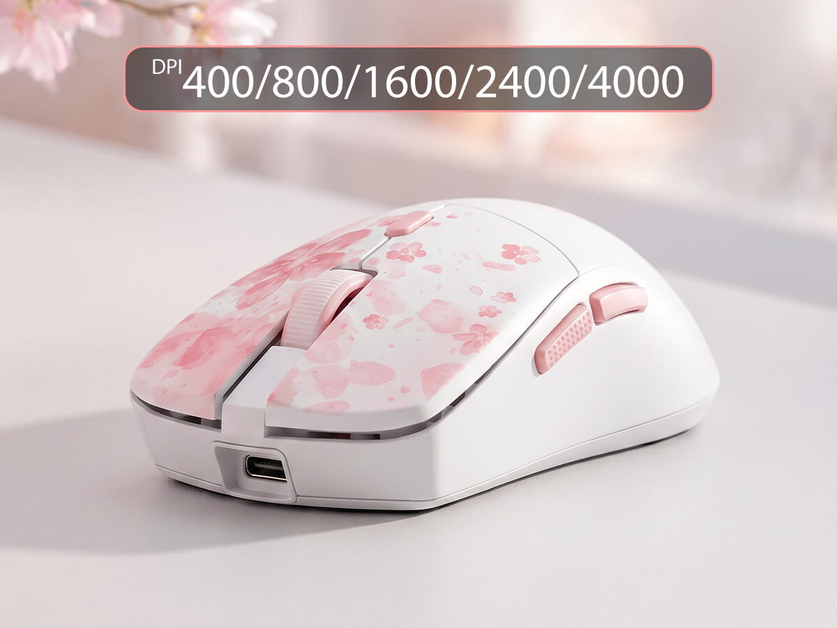 A white wireless gaming mouse with pink cherry blossom patterns on the top, shown on a light gray surface with a soft-focus background. A dark gray text banner at the top reads 'DPI 400/800/1600/2400/4000'.