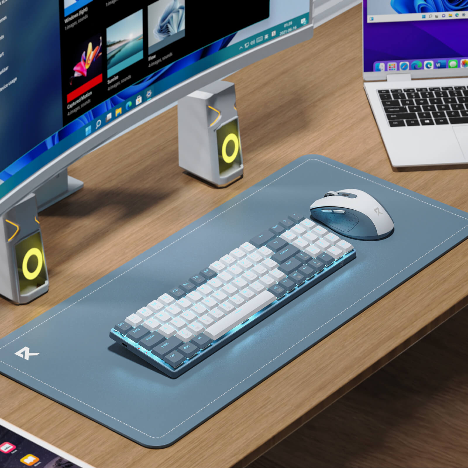 The keyboard and mouse are shown in a clean, modern office setup, with a monitor, speakers, and a portable speaker in the background.