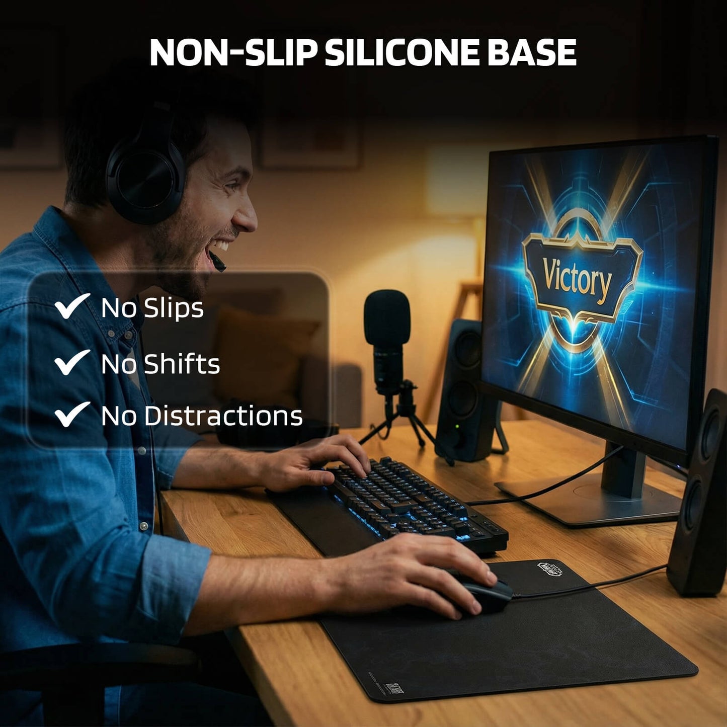 A gamer celebrates a 'Victory' on screen while using the mouse pad, emphasizing its 'NON-SLIP SILICONE BASE' with 'No Slips, No Shifts, No Distractions' checkmarks.