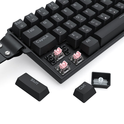A black keyboard (with a portable strap) is shown with keycaps removed, exposing pink hot-swap switches—demonstrating its customizable keycap/switch setup.