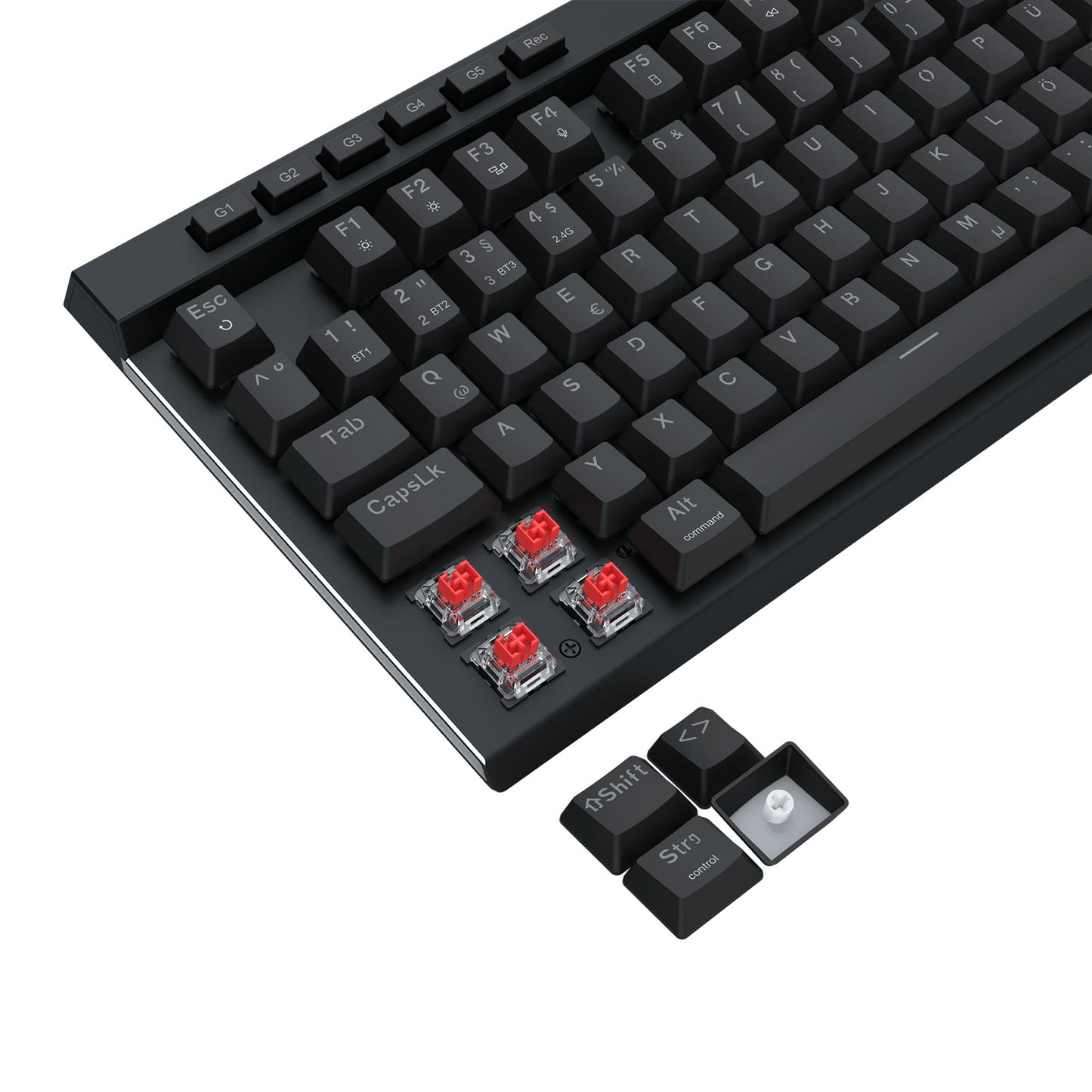 A close-up of a black mechanical keyboard with silver trim and four exposed red switch capsules near the bottom left, plus a small detached keycap cluster on a black background.