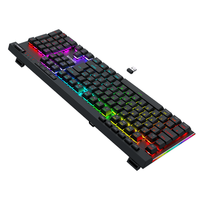 A black mechanical keyboard with vibrant RGB rainbow backlighting, shown at an angle on a solid black background with a small USB receiver nearby.