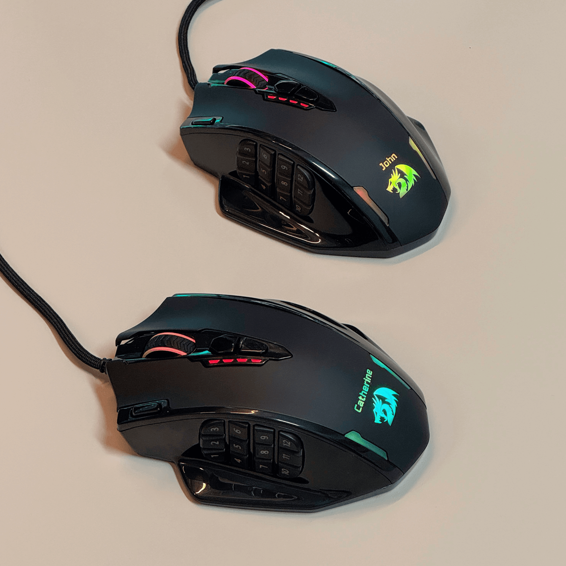 Redragon Two black gaming mice with RGB lighting on a beige background