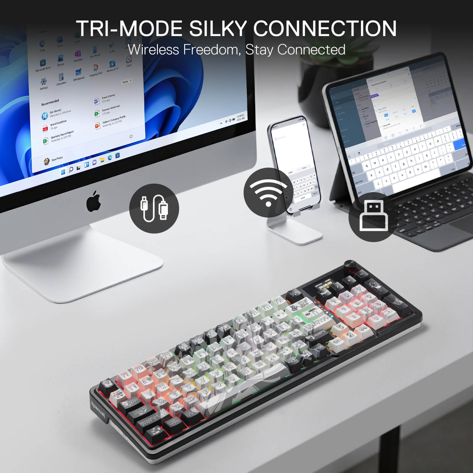Keyboard with tri-mode connection features displayed on a desk with computer, phone, and tablet.