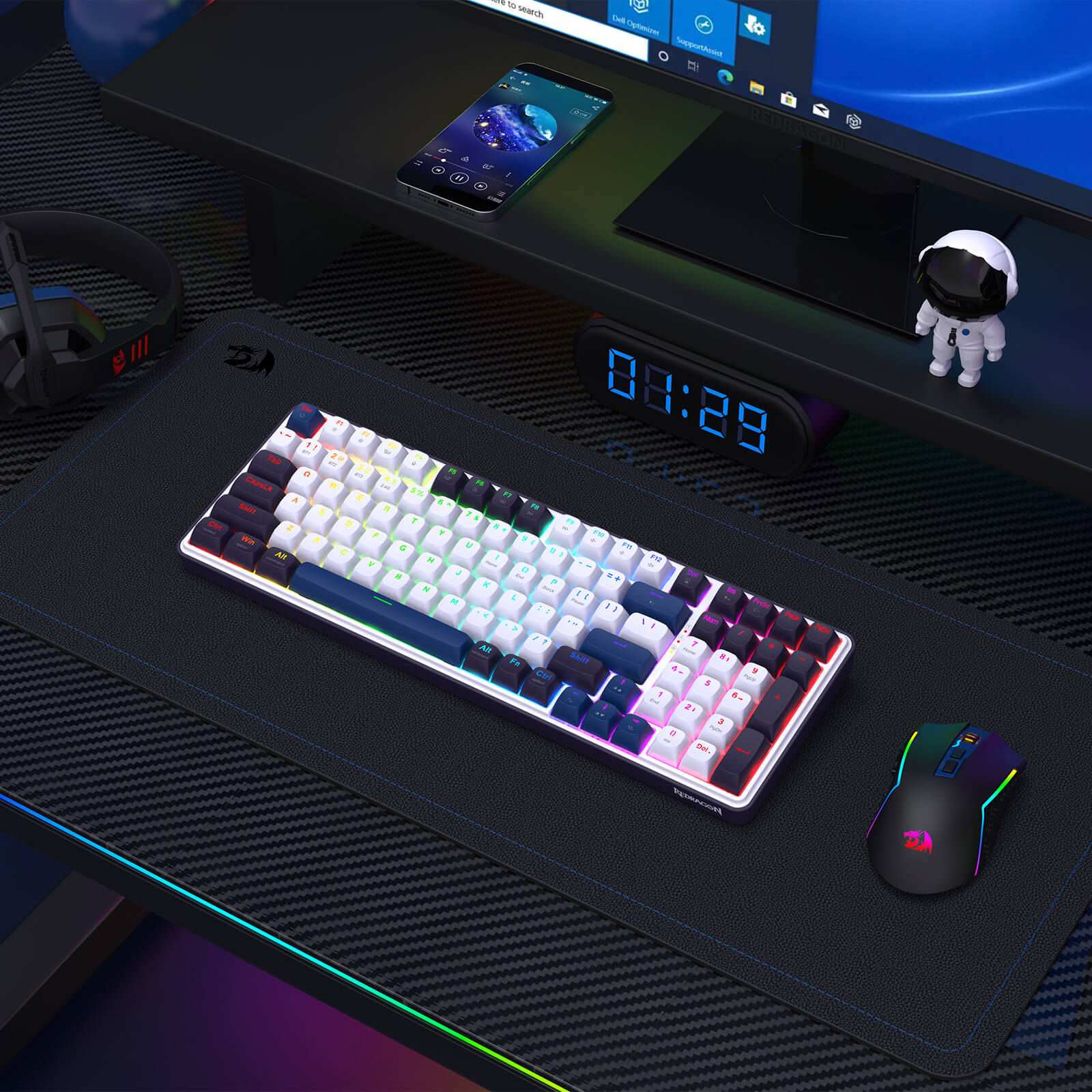 Gaming desk setup with keyboard, mouse, and monitor on a dark surface
