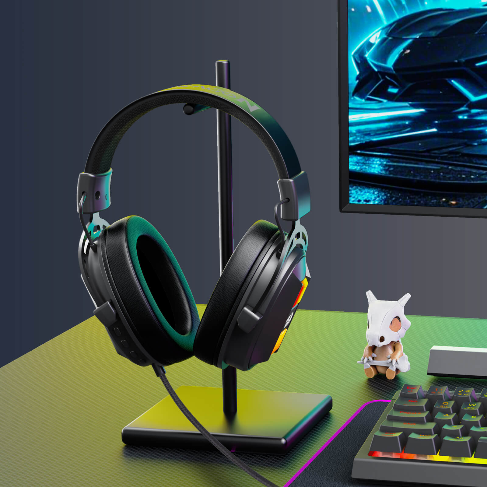 Gaming headset on a stand with a computer monitor, keyboard, and small figurine in the background.