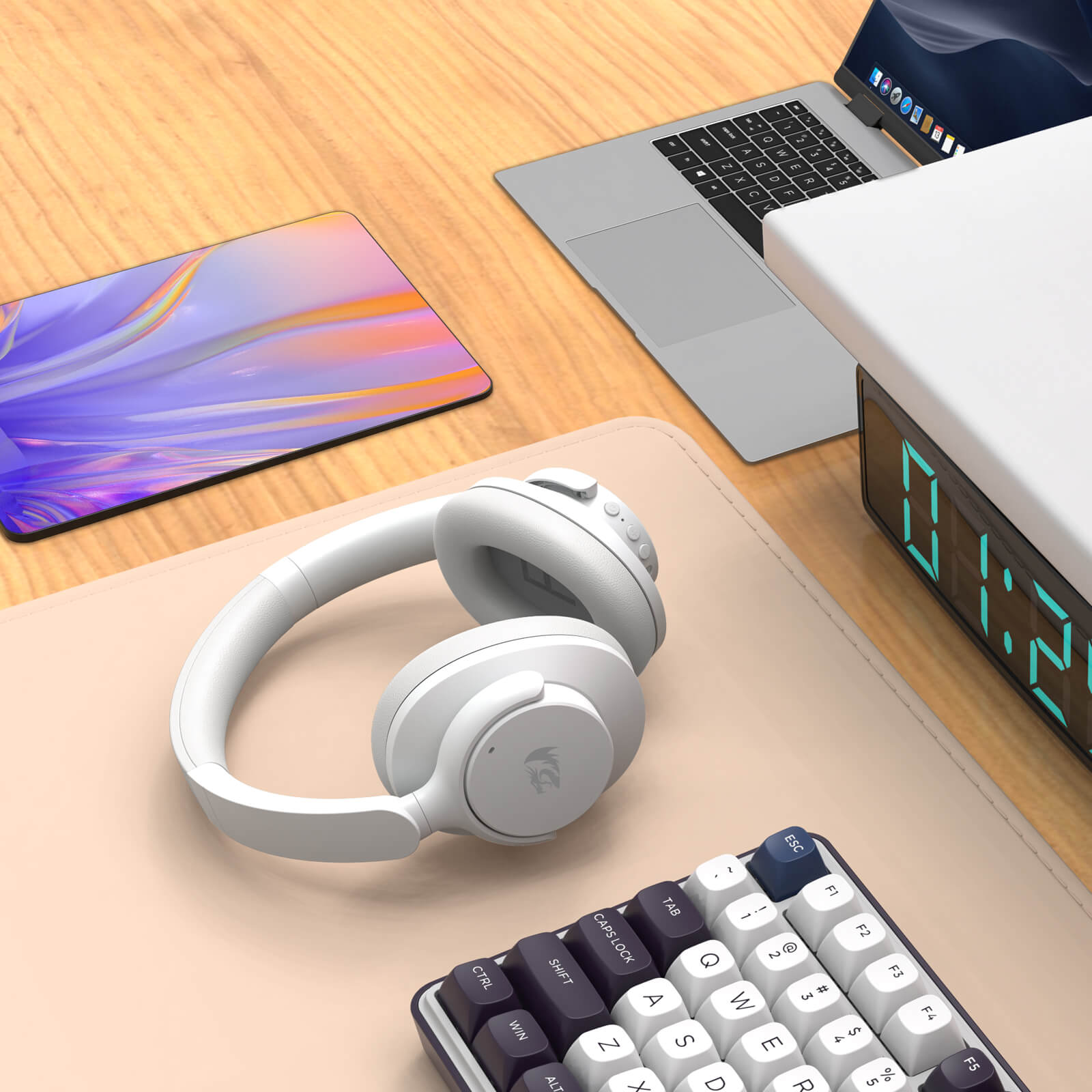 White headphones on a desk with a laptop, tablet, and digital clock in the background.