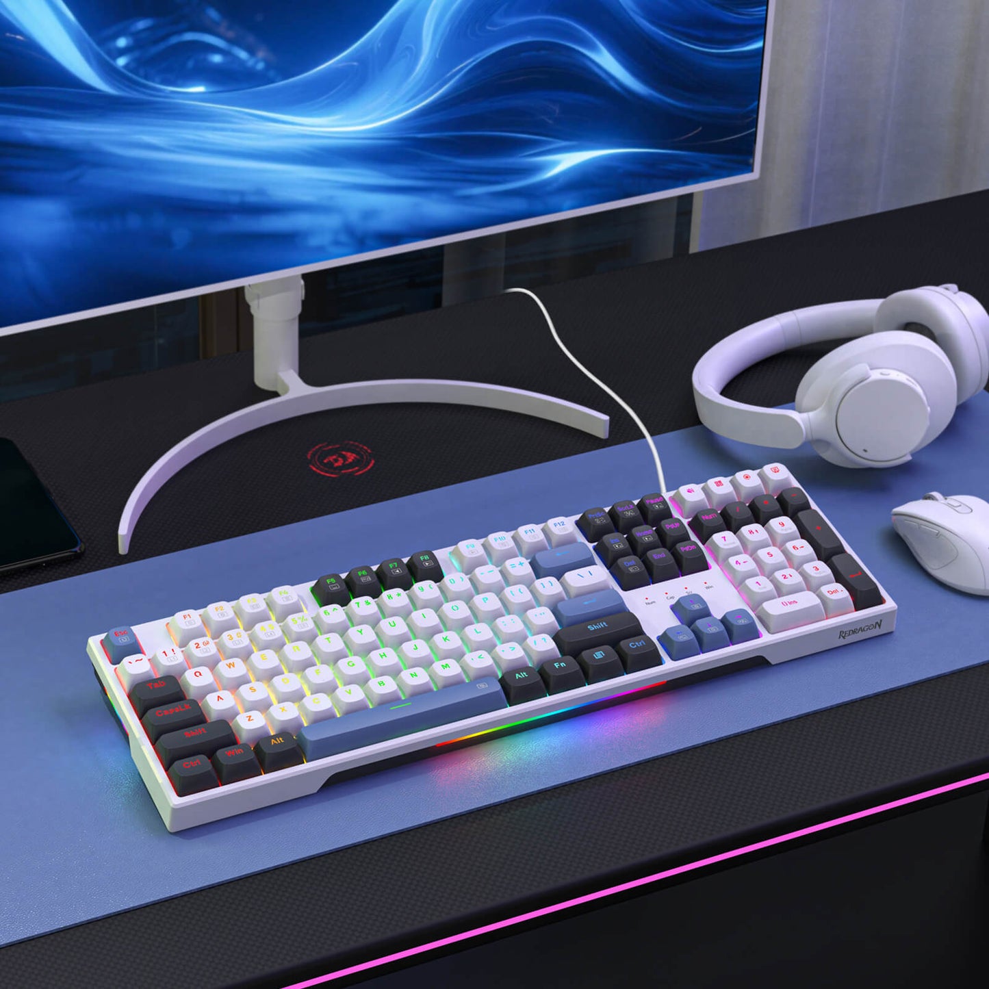 Redragon K668 Mechanical keyboard on a desk with a monitor, headphones, and mouse in the background