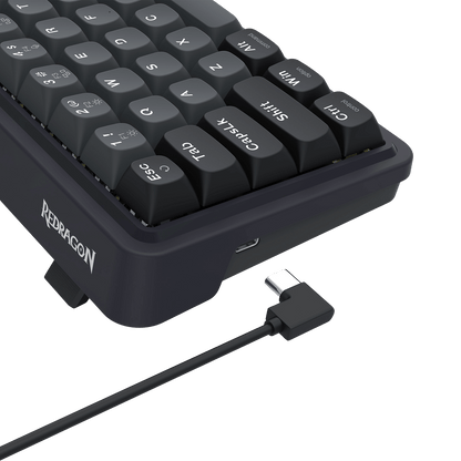 Black keyboard with USB cable on a black background, featuring the Redragon brand.