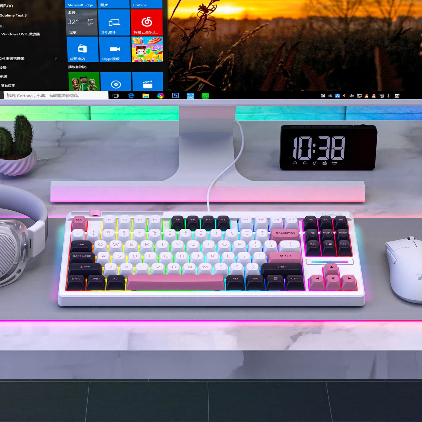 Redragon Keyboard on a desk with a computer monitor displaying a colorful interface, clock, and cactus plant.