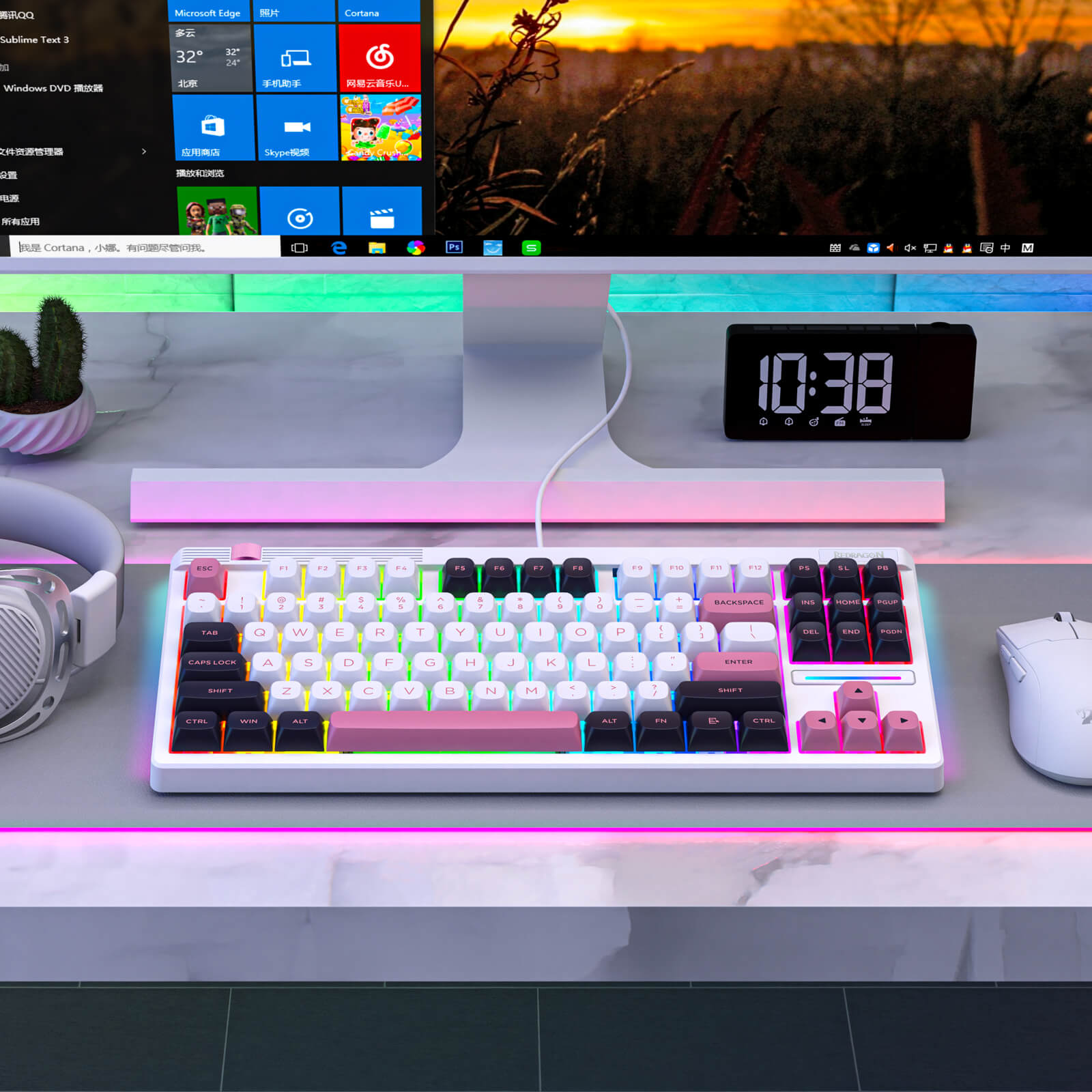 Redragon Keyboard on a desk with a computer monitor displaying a colorful interface, clock, and cactus plant.