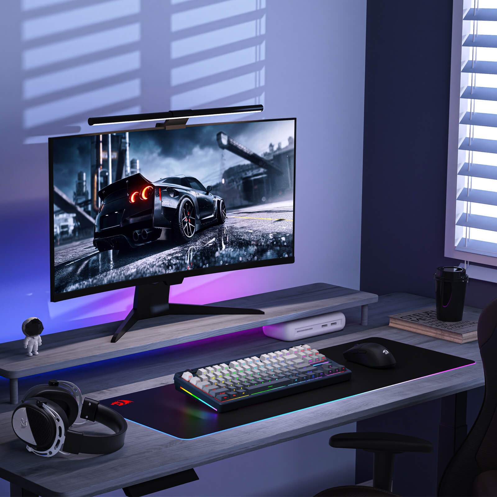 Gaming setup with monitor, keyboard, mouse, and headphones on a desk.