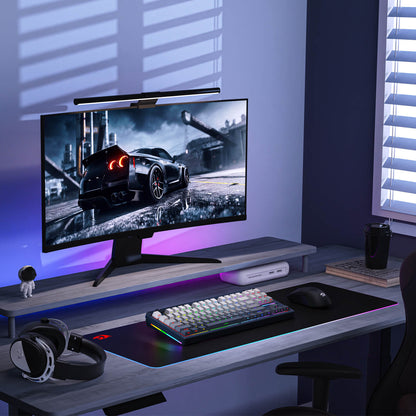 Gaming setup with monitor, keyboard, mouse, and headphones on a desk.