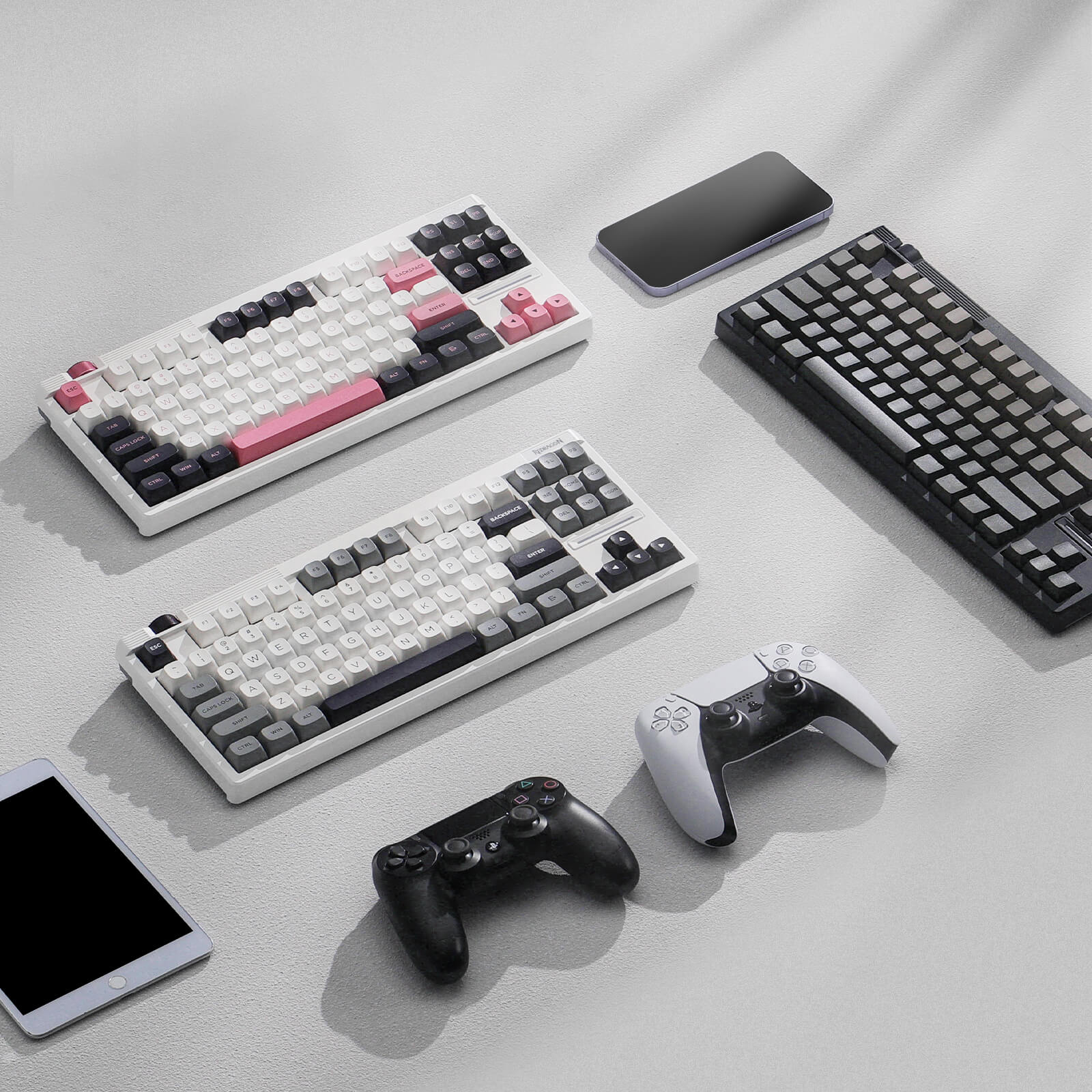 Collection of Redragon K729 series mechanical keyboards and gaming controllers on a light gray surface