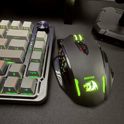 Redragon Gaming keyboard and mouse with green illuminated text on a dark surface