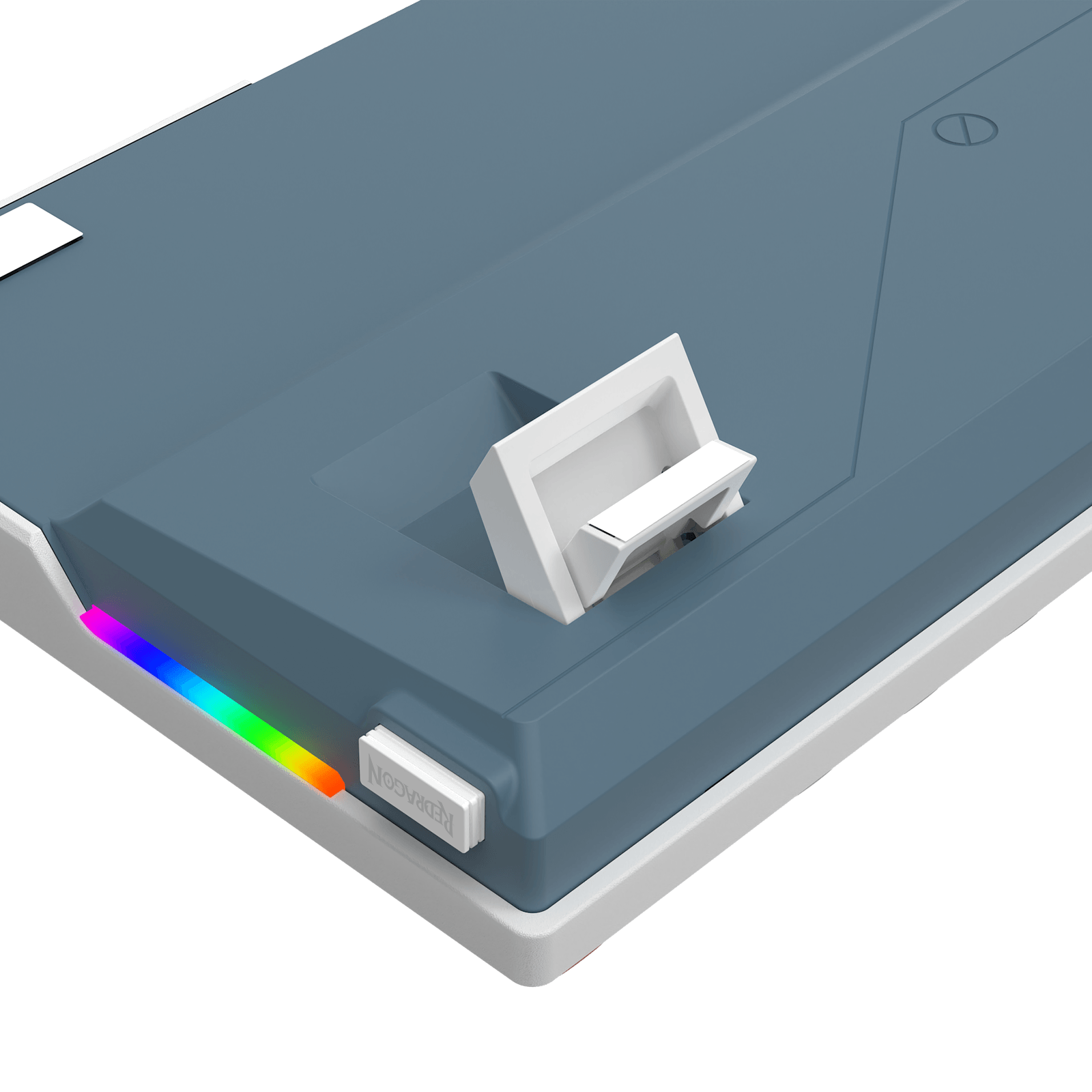 A close-up of a slate blue and white electronic device, likely a power bank or charging hub, featuring a white latch on top, a small white button, and a vibrant RGB rainbow light strip along the edge, shown against a solid black background.