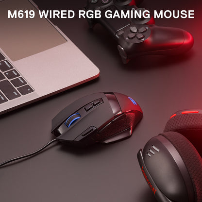 The Redragon M619 wired RGB gaming mouse is shown in a setup (laptop, controller, headset), highlighting its sleek design and RGB accents.