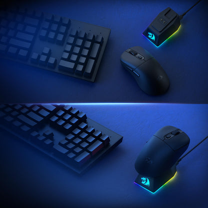 The gaming mouse is displayed with its RGB magnetic charging dock and a mechanical keyboard, emphasizing the complete wireless gaming setup.