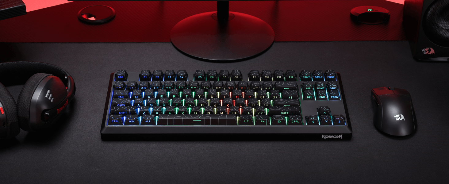 Redragon K737 PRO Gaming keyboard with RGB lighting on a dark desk with mouse and headphones.