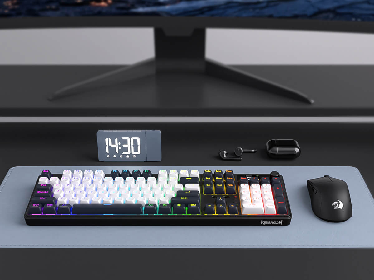 Gaming setup with keyboard, mouse, and monitor on a desk.