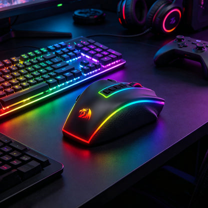 A gaming mouse with RGB rainbow lighting and a dragon logo, shown on a dark desk alongside a keyboard, controller, and headphones.