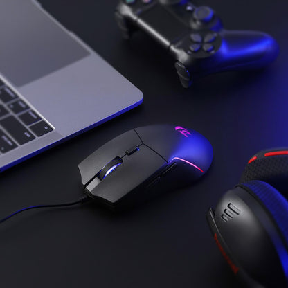 A close-up of the Redragon gaming mouse (with RGB backlighting) is shown on a desk, paired with a laptop, controller, and headset to highlight its fit in a gaming setup.
