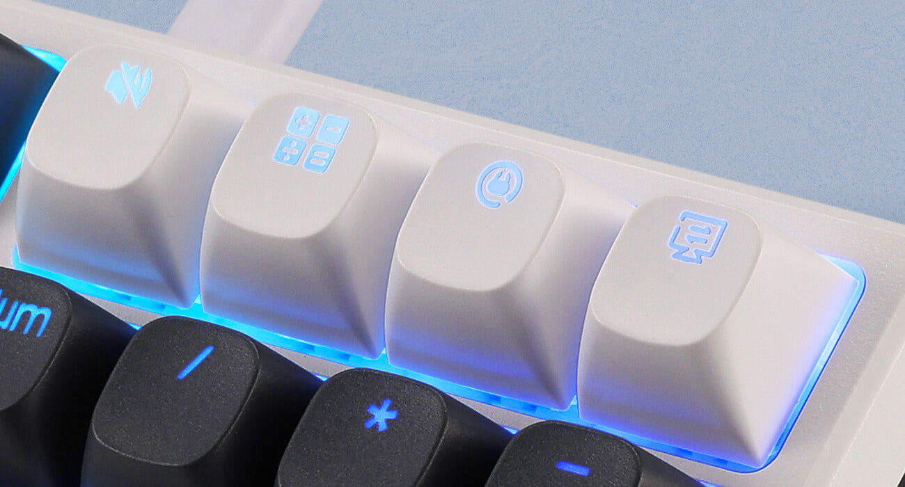 Close-up of a mechanical keyboard with illuminated keys on a light gray background