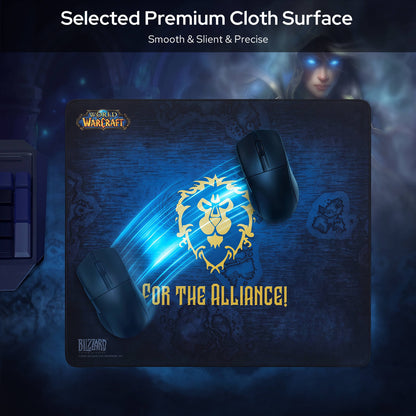 A large dark blue Warcraft-themed gaming mouse pad with a gold lion emblem and the text 'FOR THE ALLIANCE!' shown on a dark promotional background. Two black computer mice are placed on top of the pad, and the top of the image includes the text 'Selected Premium Cloth Surface' with a blurred fantasy character in the background.